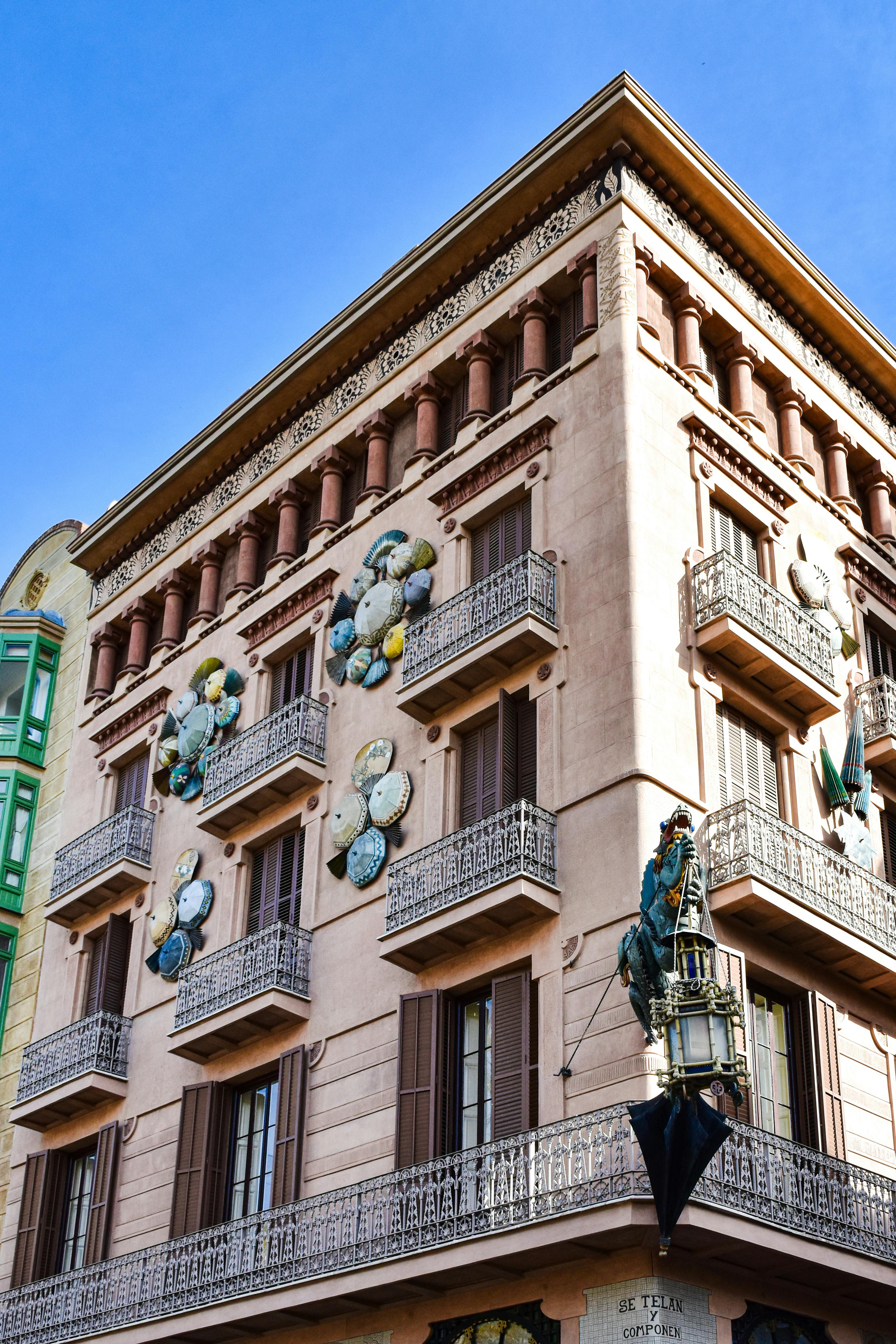 a building with a balcony and a statue on it