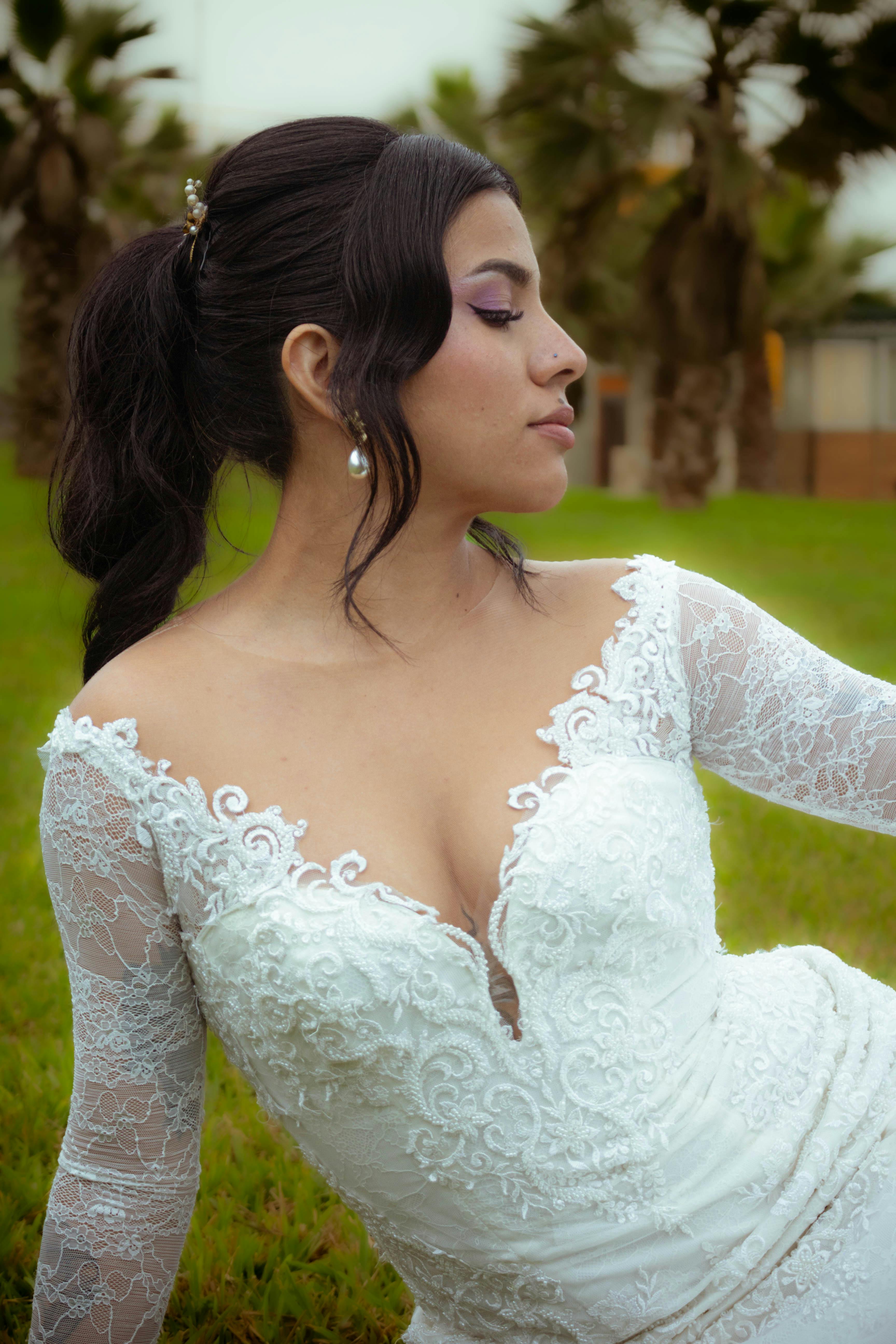 a woman in a wedding dress poses for a photo