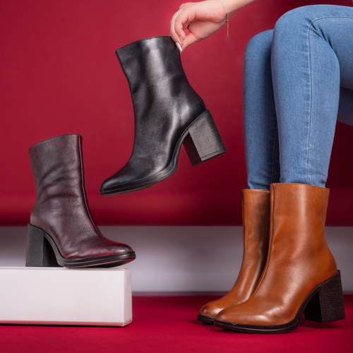 Free Stylish women's ankle boots in leather and suede, perfect for fashion footwear collections. Stock Photo