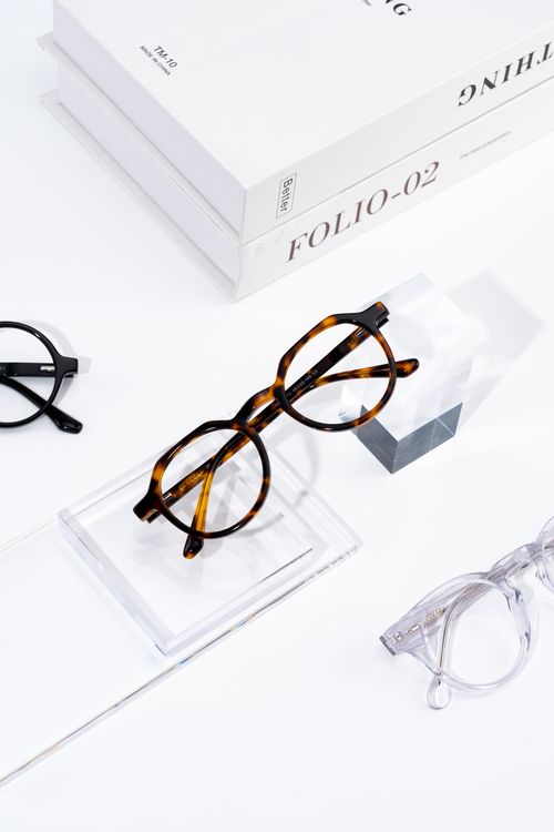 Free Glasses collection on a stylish minimalist surface, perfect for fashion and eyewear themes. Stock Photo