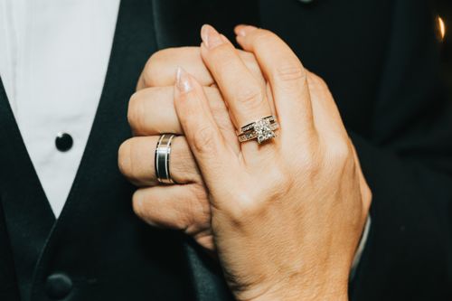 Free A romantic close-up of holding hands showcasing elegant wedding rings, symbolizing love and unity. Stock Photo