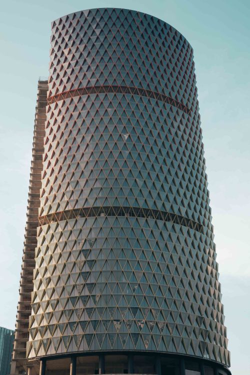 Rotationg Triangular High Rise A tall building with a triangular shape on top · Free Stock Photo