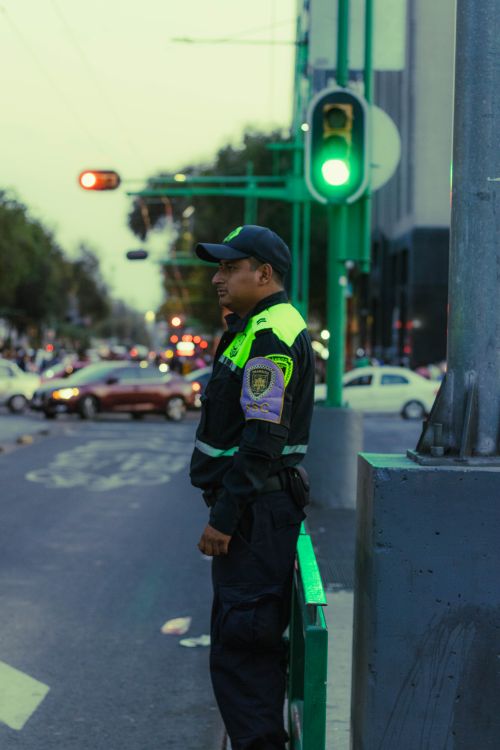 Free A traffic officer monitors vehicles at a busy intersection in Mexico City during daylight. Stock Photo