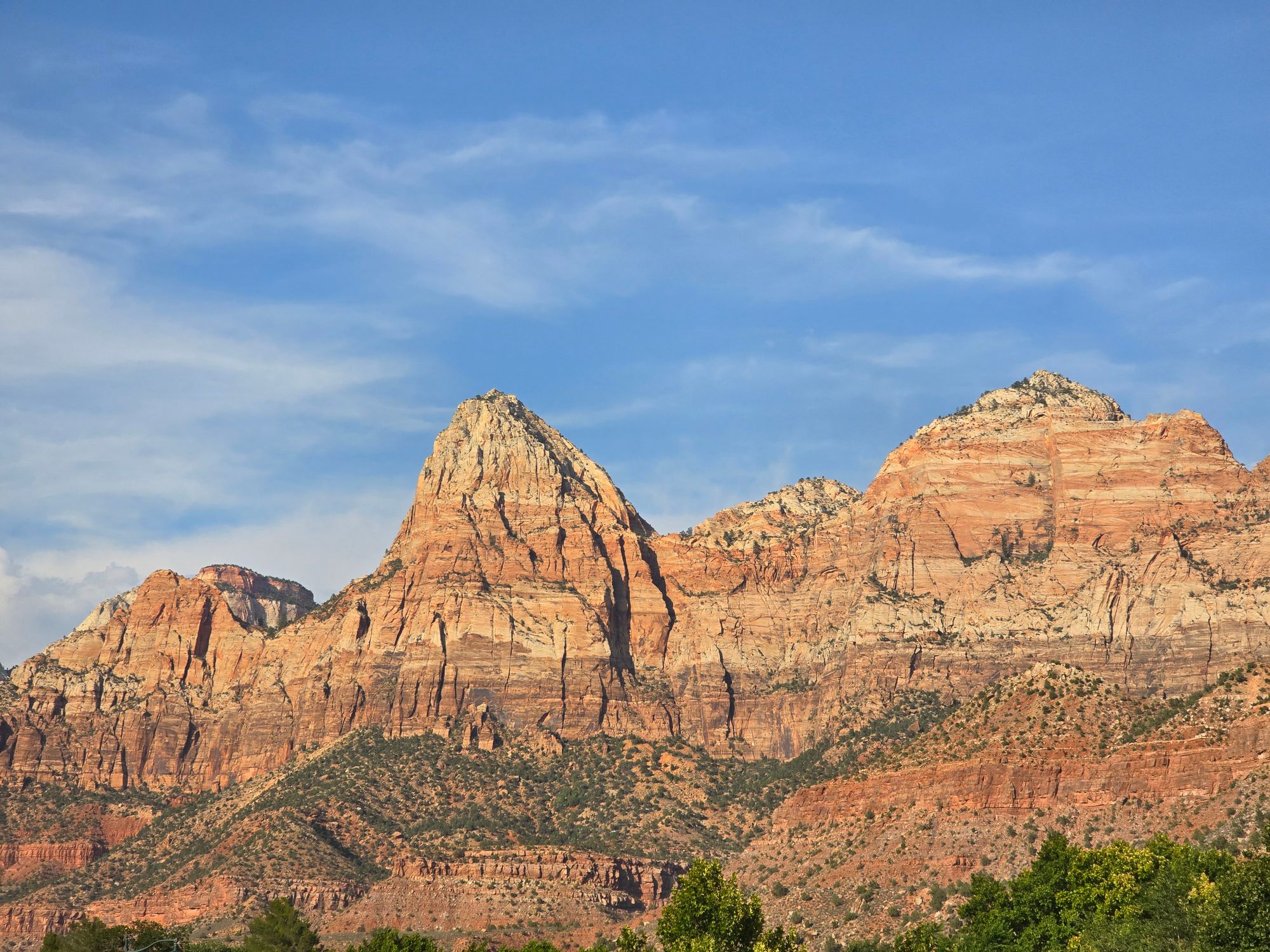Stunning view of the sandstone cliffs in Zion National Park, Utah, under a clear blue sky.