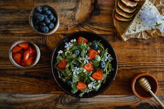 Healthy fruit and salad arrangement on rustic wooden table. Perfect for organic food concepts.