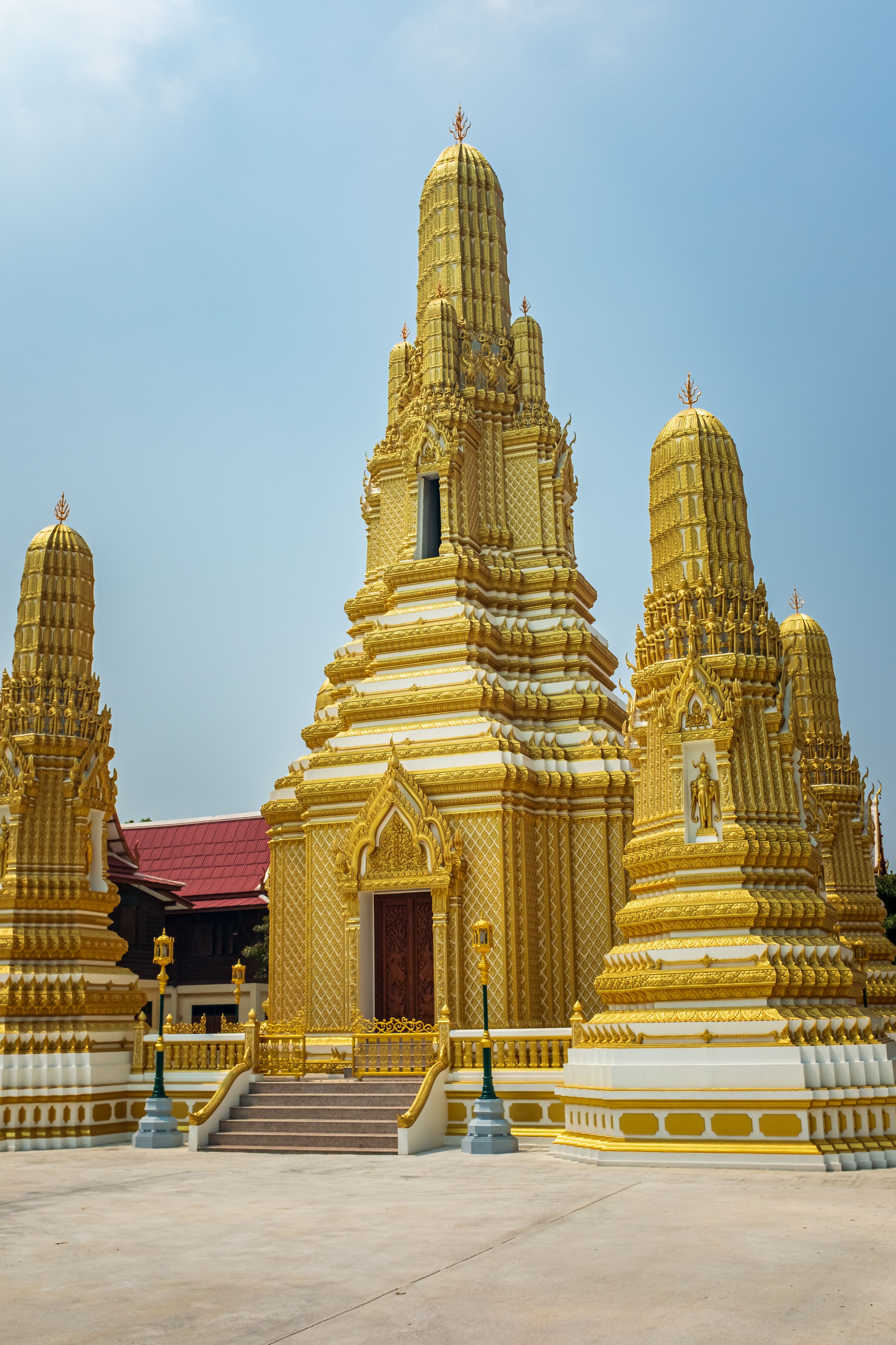 A golden Buddhist temple stupa showcasing ornate Thai architecture.