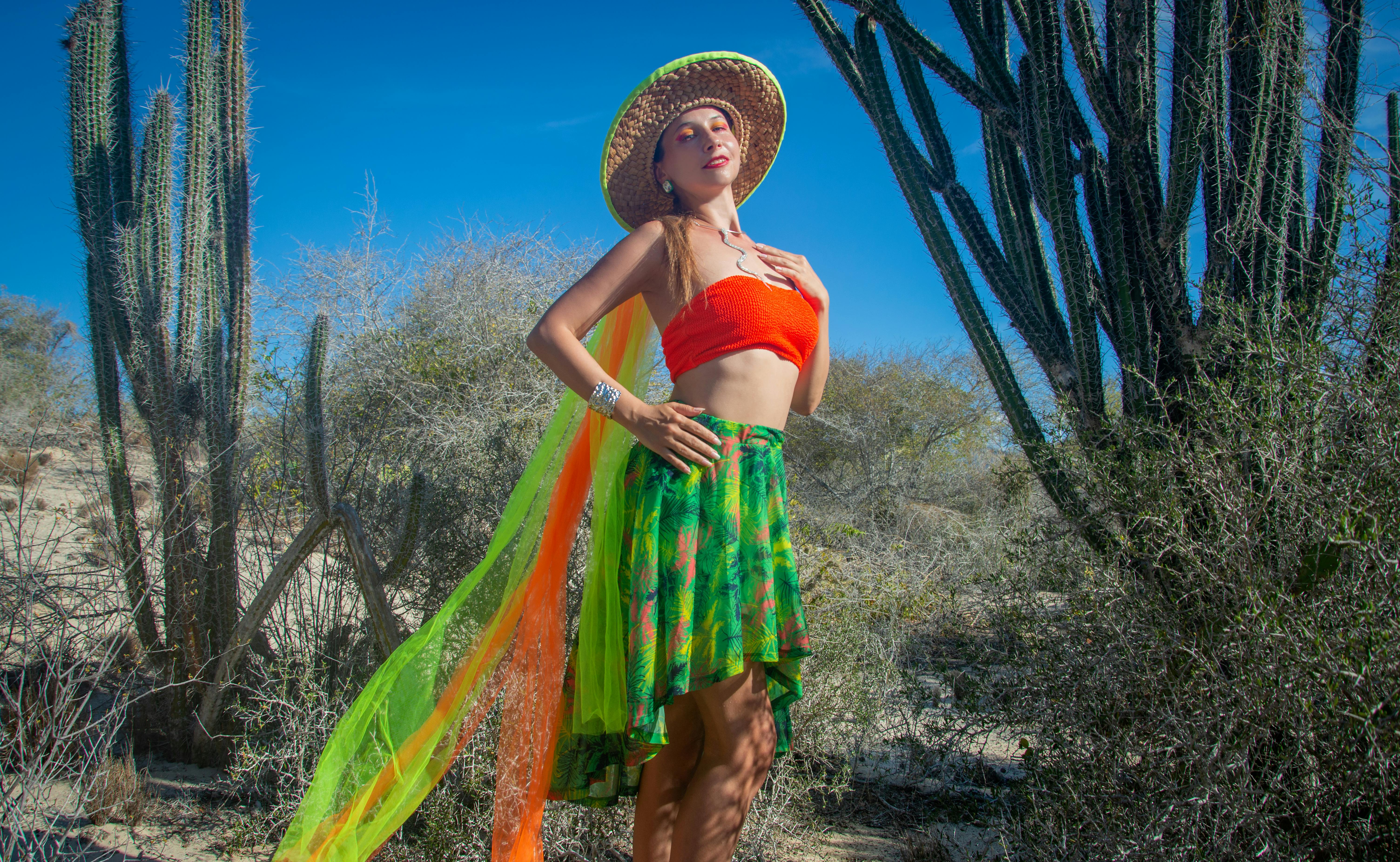 a woman in a colorful skirt posing in the desert