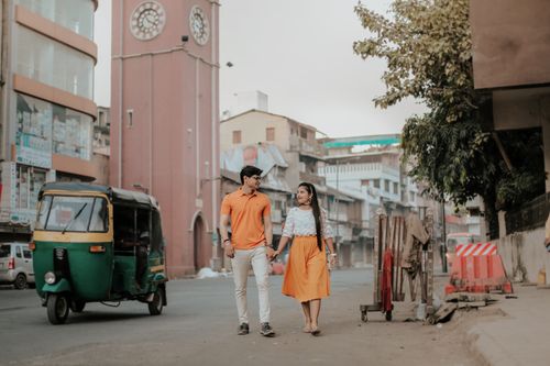 Free Young couple walking hand in hand through the urban streets of Surat, India. Stock Photo