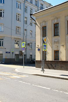 Street scene in Moscow with classic architecture and road signs under clear daylight.