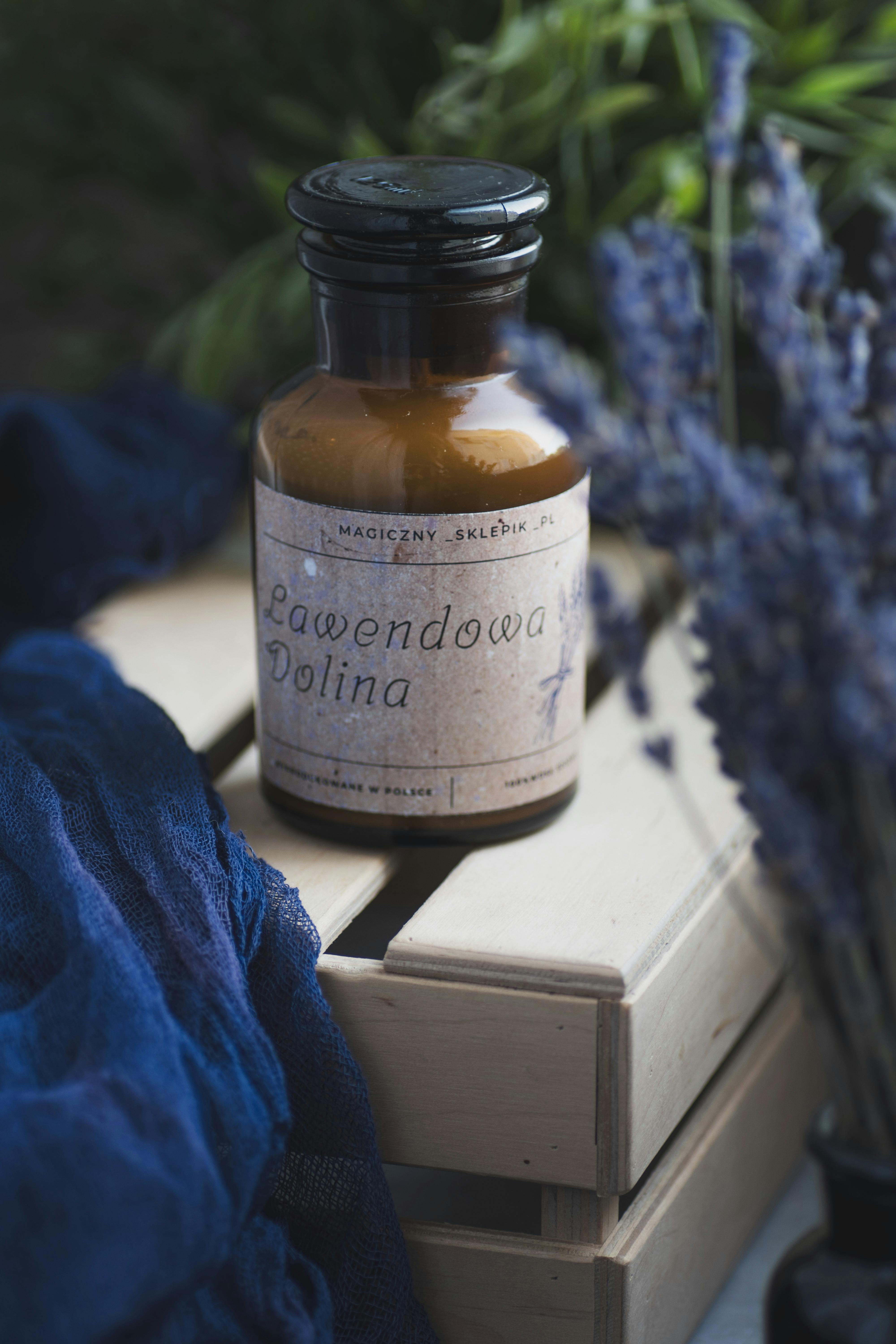 A bottle of lavender oil sitting on top of a wooden crate