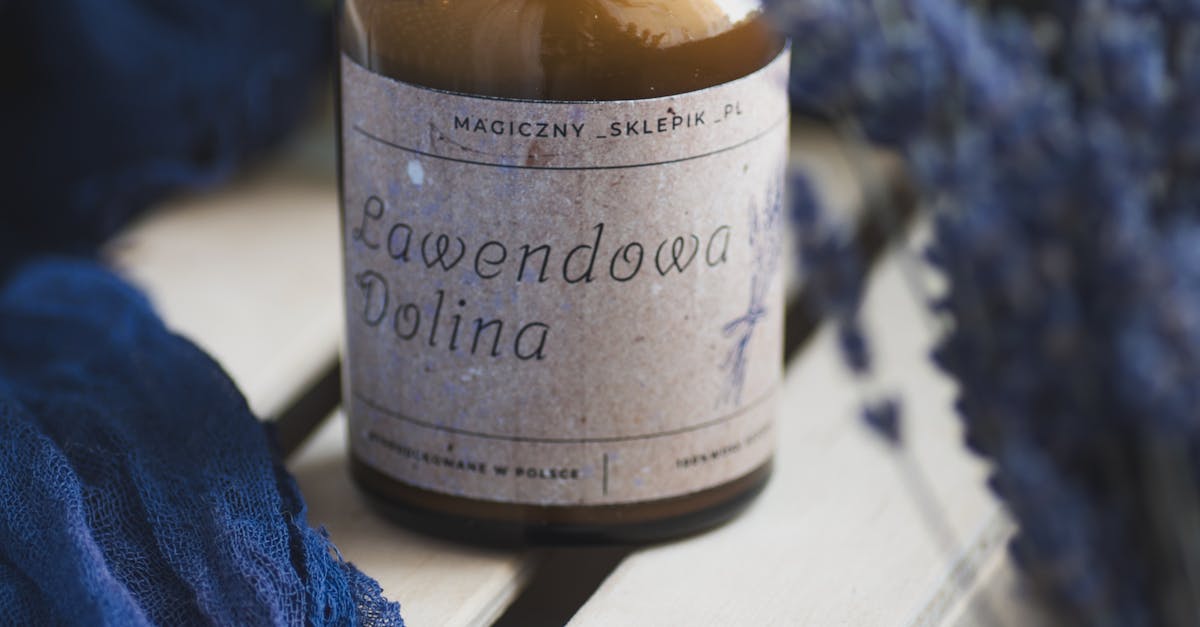 A bottle of lavender oil sitting on top of a wooden crate
