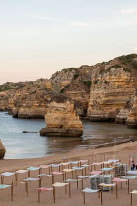 Quiet cove with sun loungers below sandstone cliffs — photo by William Larsen on Pexels