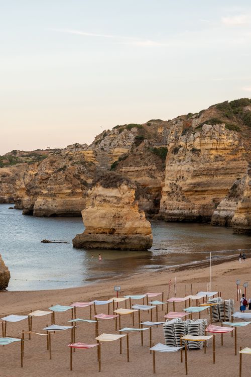 Free Tranquil beach scene with unique rock formations along the Lisbon coast. Stock Photo