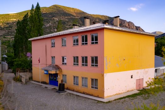 A vibrant building in the countryside of Erzurum, Türkiye, under a clear sky.