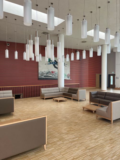 Free Spacious modern interior featuring minimalist furniture and hanging lights. Stock Photo