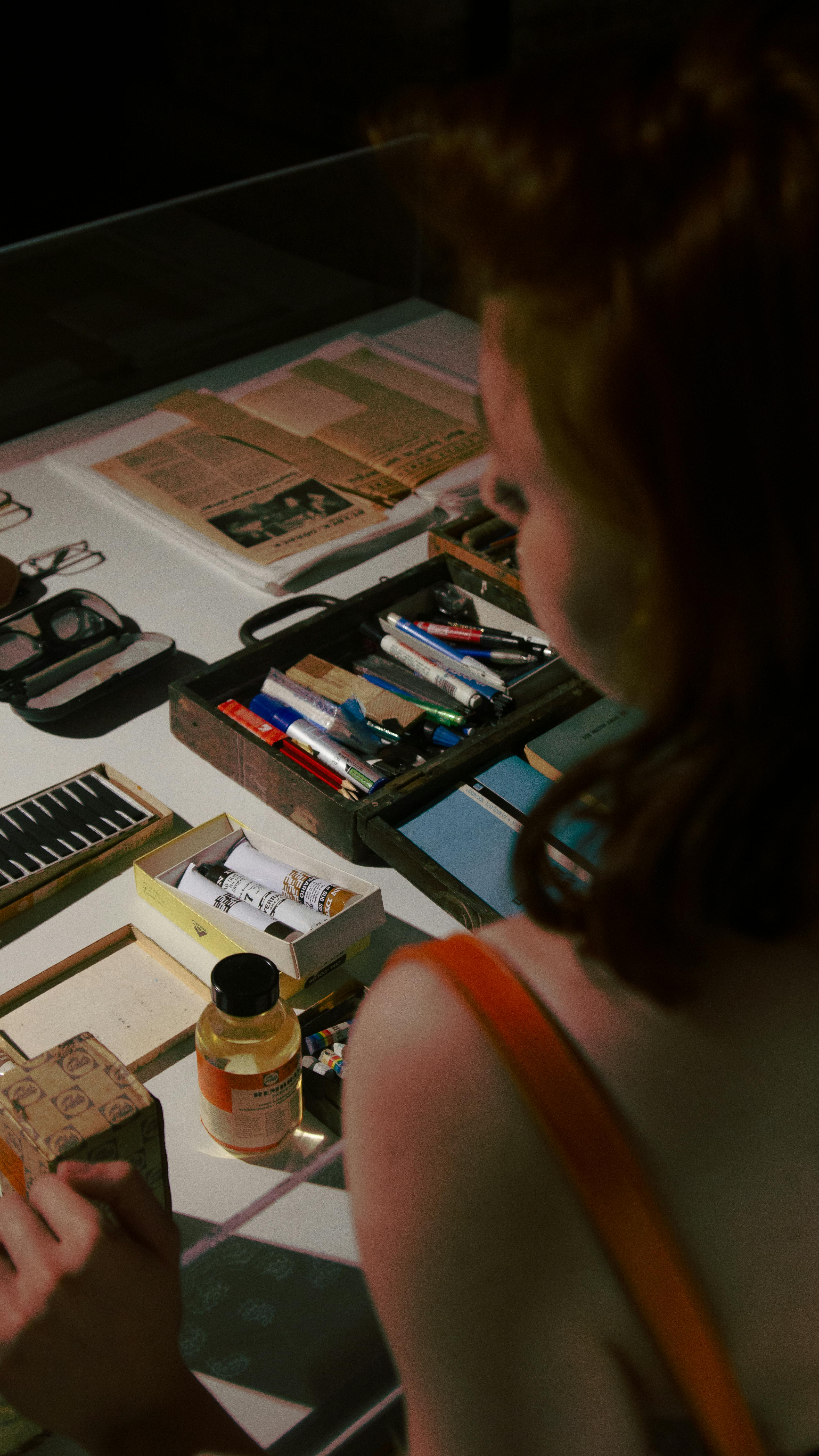 a woman is looking at a table full of items