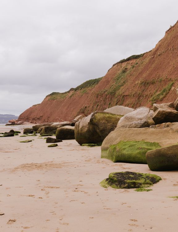 Sandy Rocks Clif's A beach with rocks and sand and a cliff · Free Stock Photo