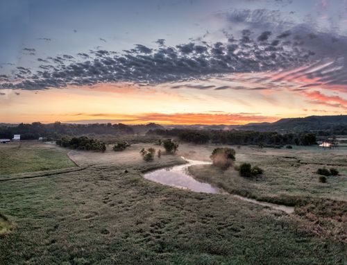 Free Breathtaking aerial view of Modena, Wisconsin at dawn with misty fields and colorful sky. Stock Photo