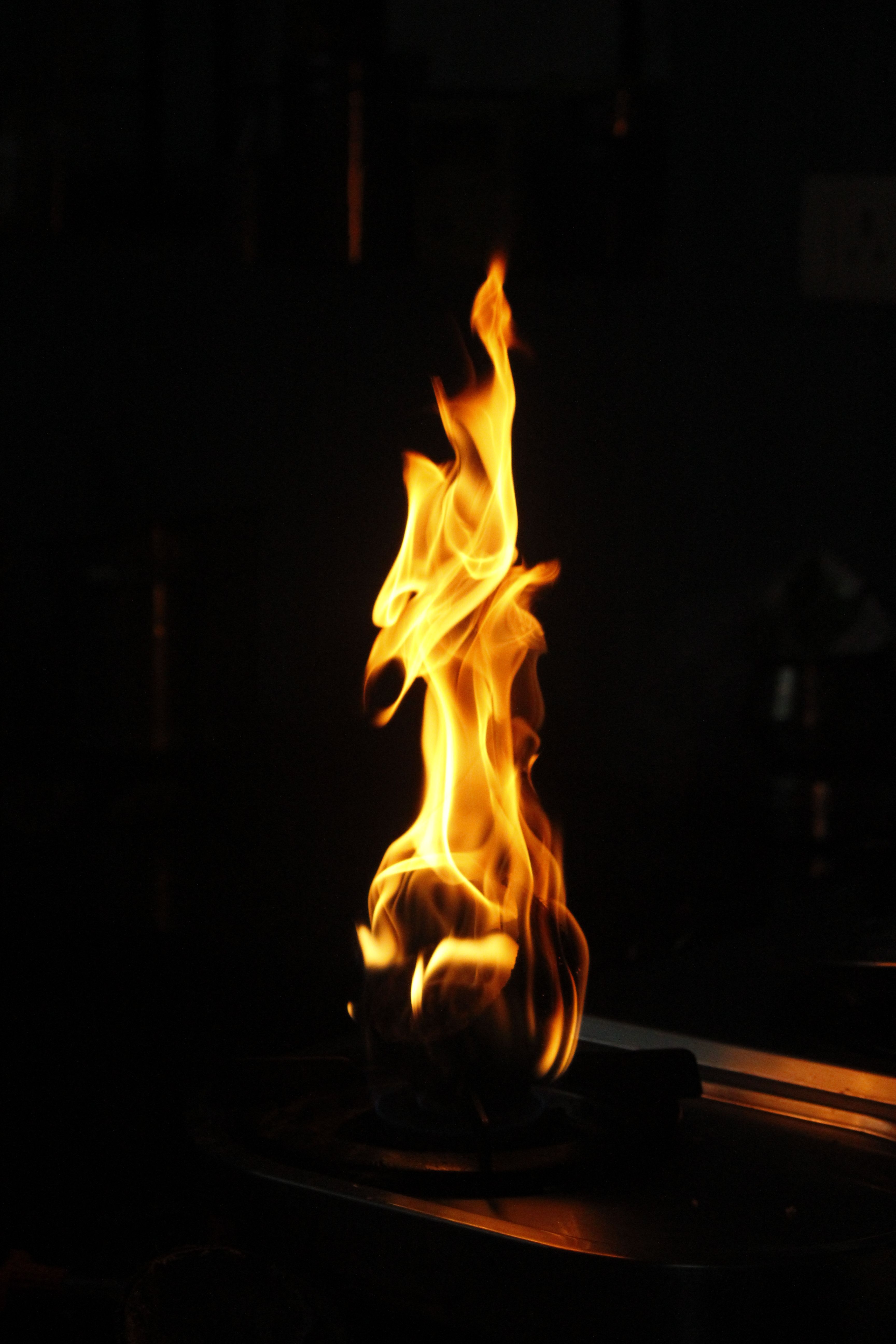 Dramatic flame rising from a burner highlighting energy and heat.