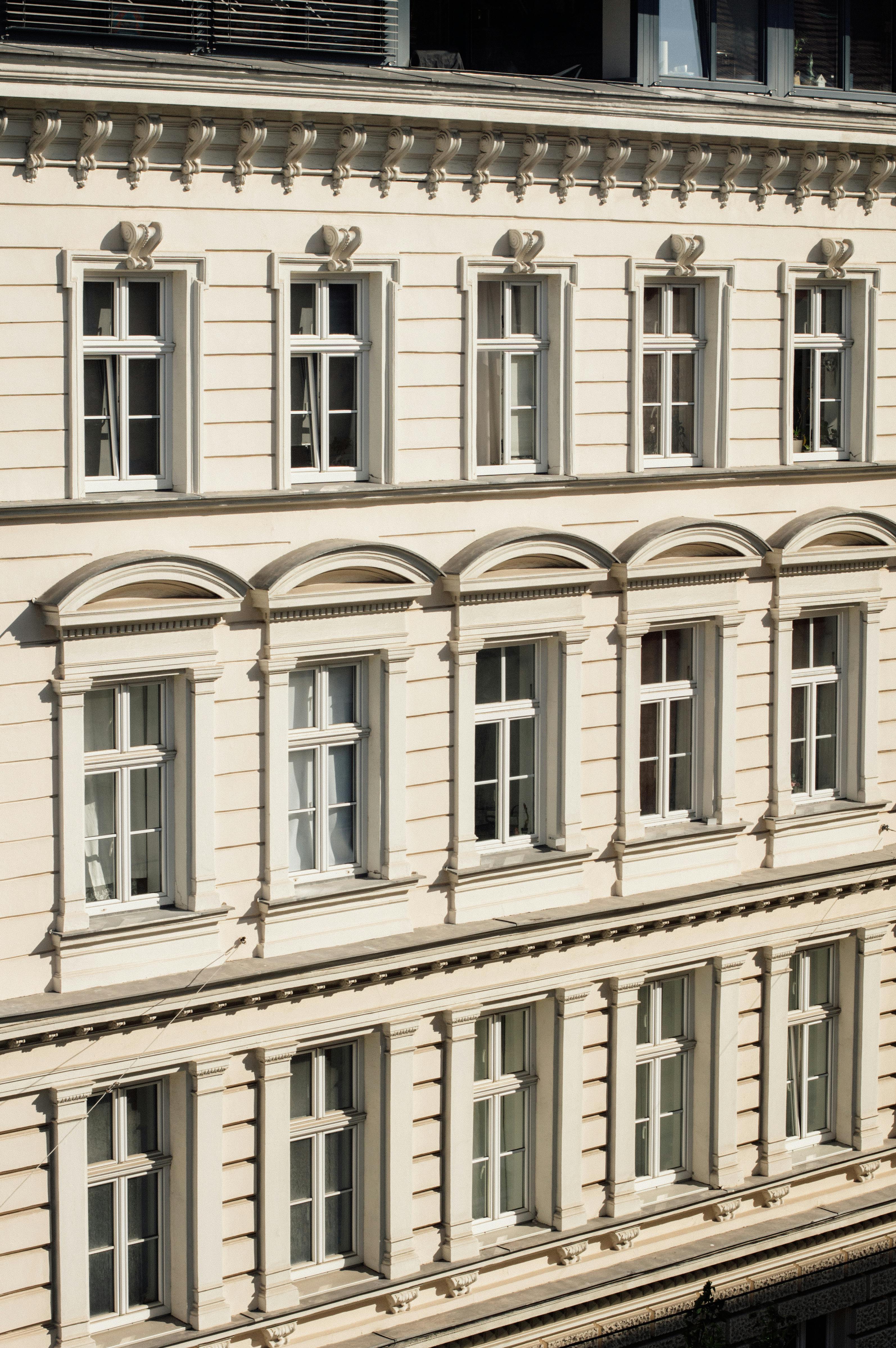 Elegant neoclassical facade of a Vienna building with detailed windows and architectural design.
