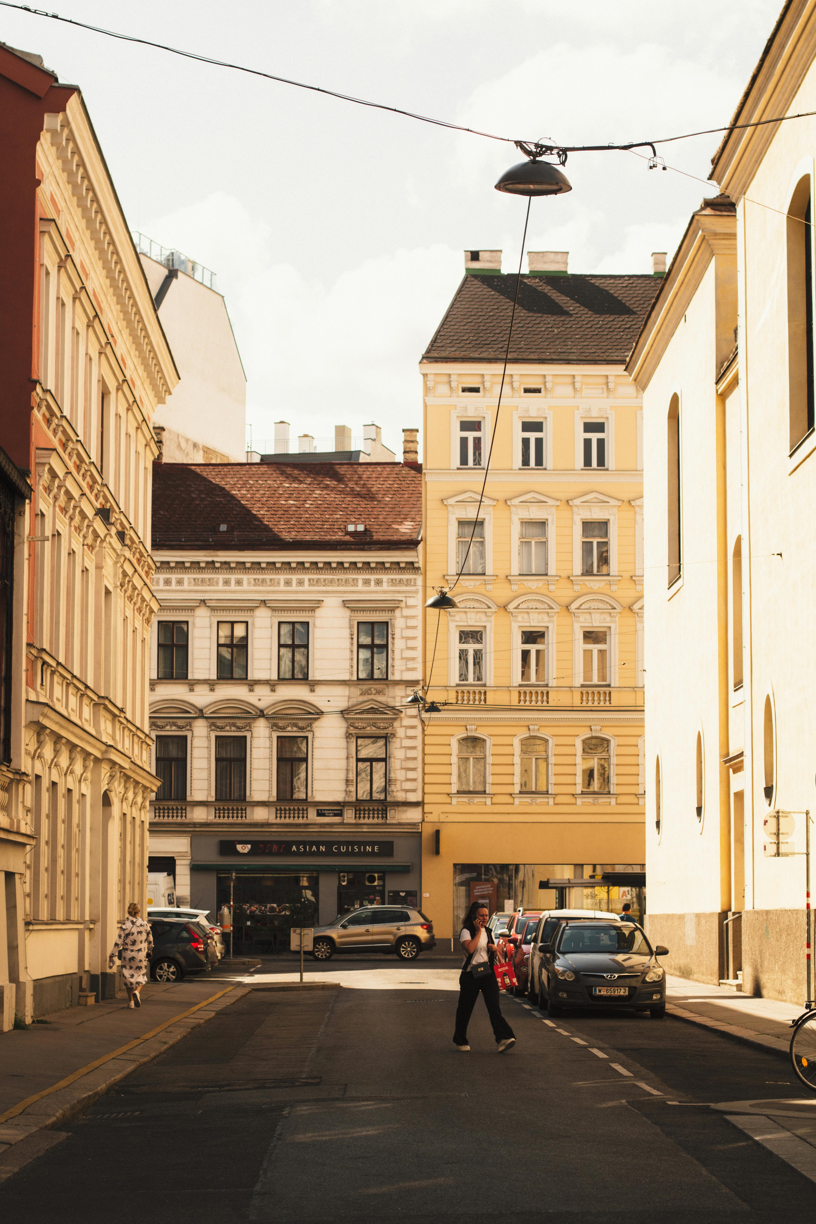 A picturesque Vienna street with classic architecture and soft lighting, capturing urban life.