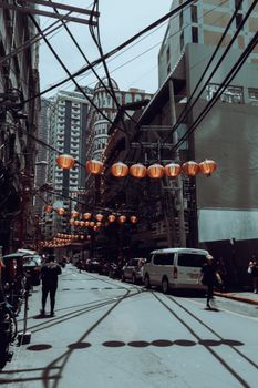 Busy street scene in Manila's Chinatown featuring lanterns and urban life.