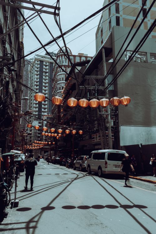 Free Busy street scene in Manila's Chinatown featuring lanterns and urban life. Stock Photo