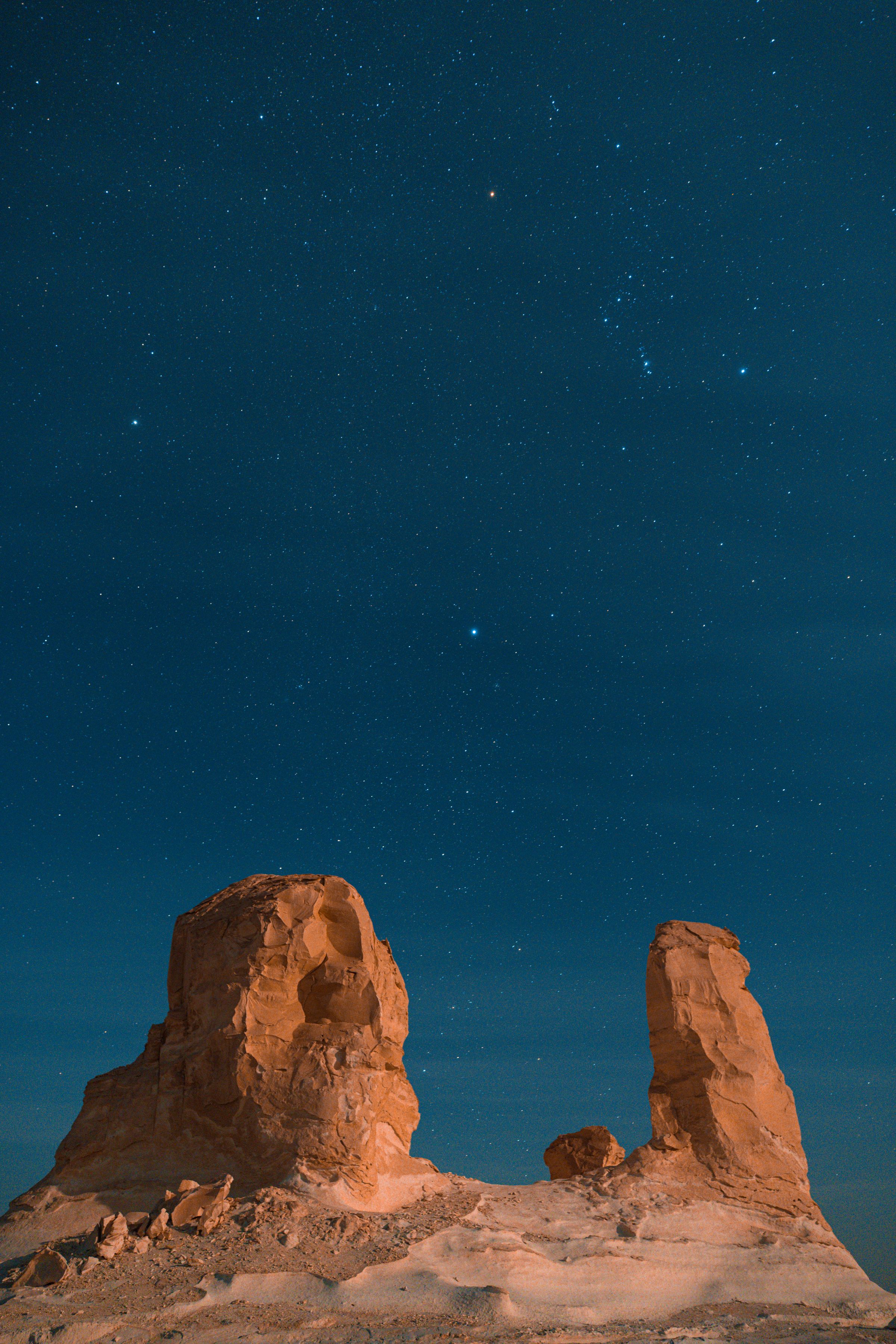 The Milky Way arcs over a vast desert rock formation in Siwa, Egypt