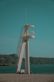 A lifeguard tower stands by the seashore in Altea, capturing the serene beauty of the Spanish coast.