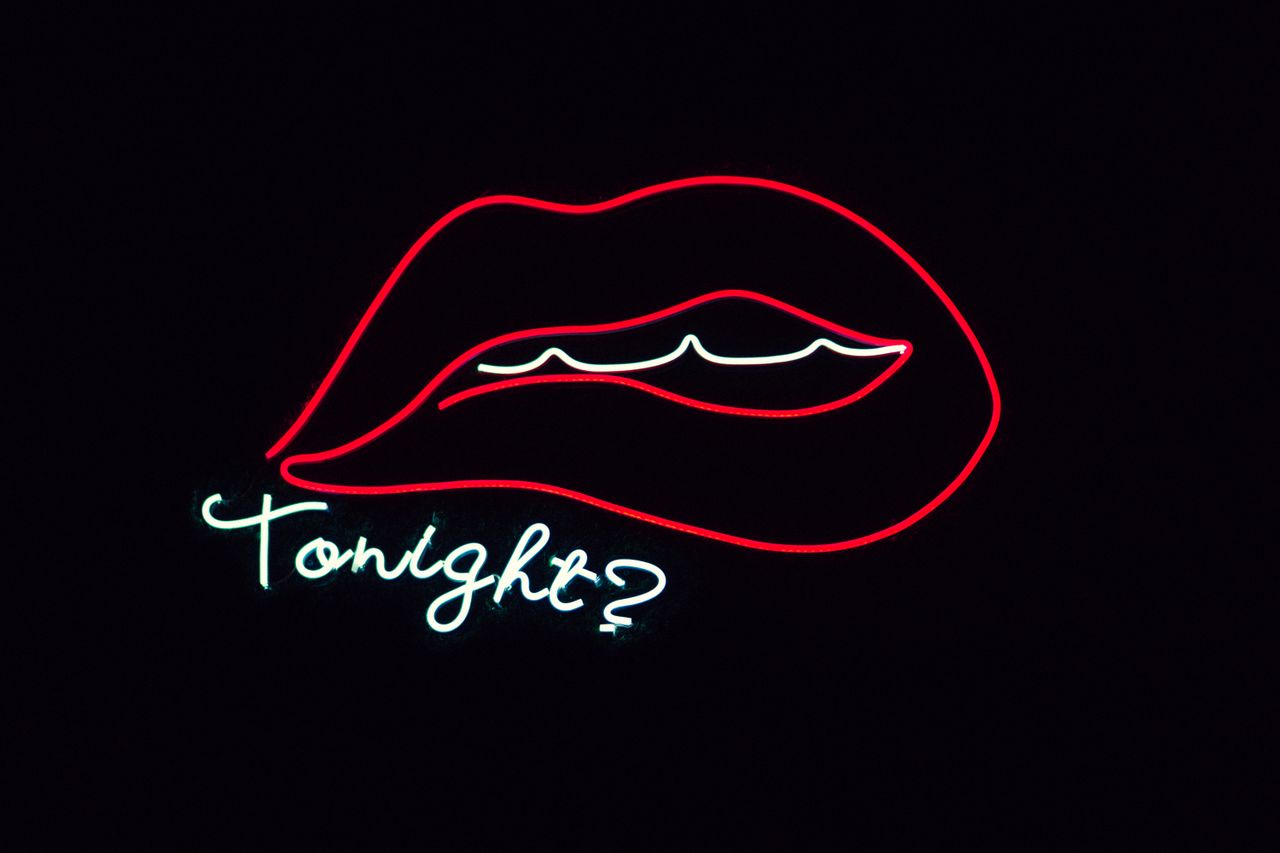creative neon sign featuring lips and tonight on a black background