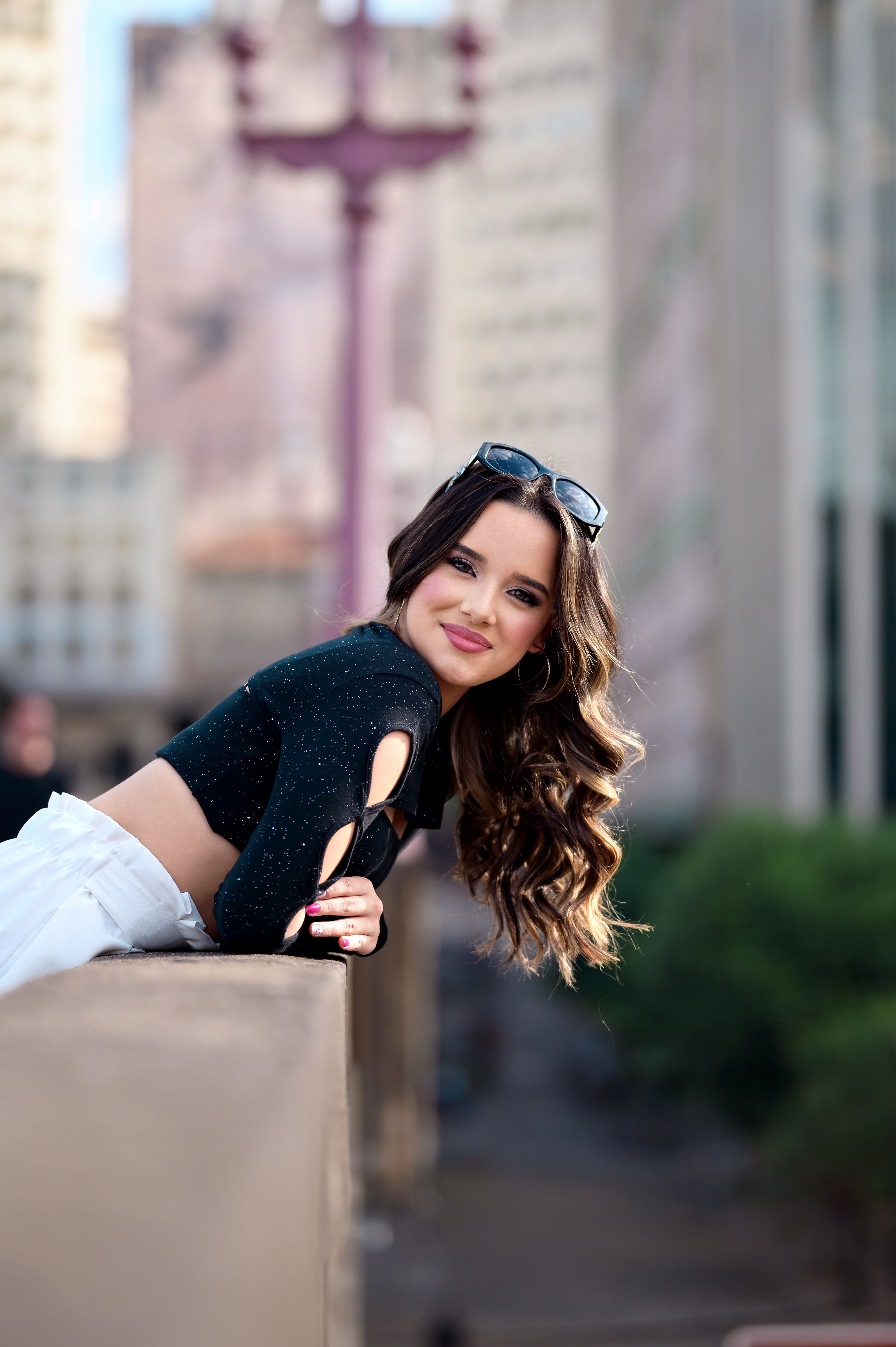 A woman leaning on a railing in a city · Free Stock Photo