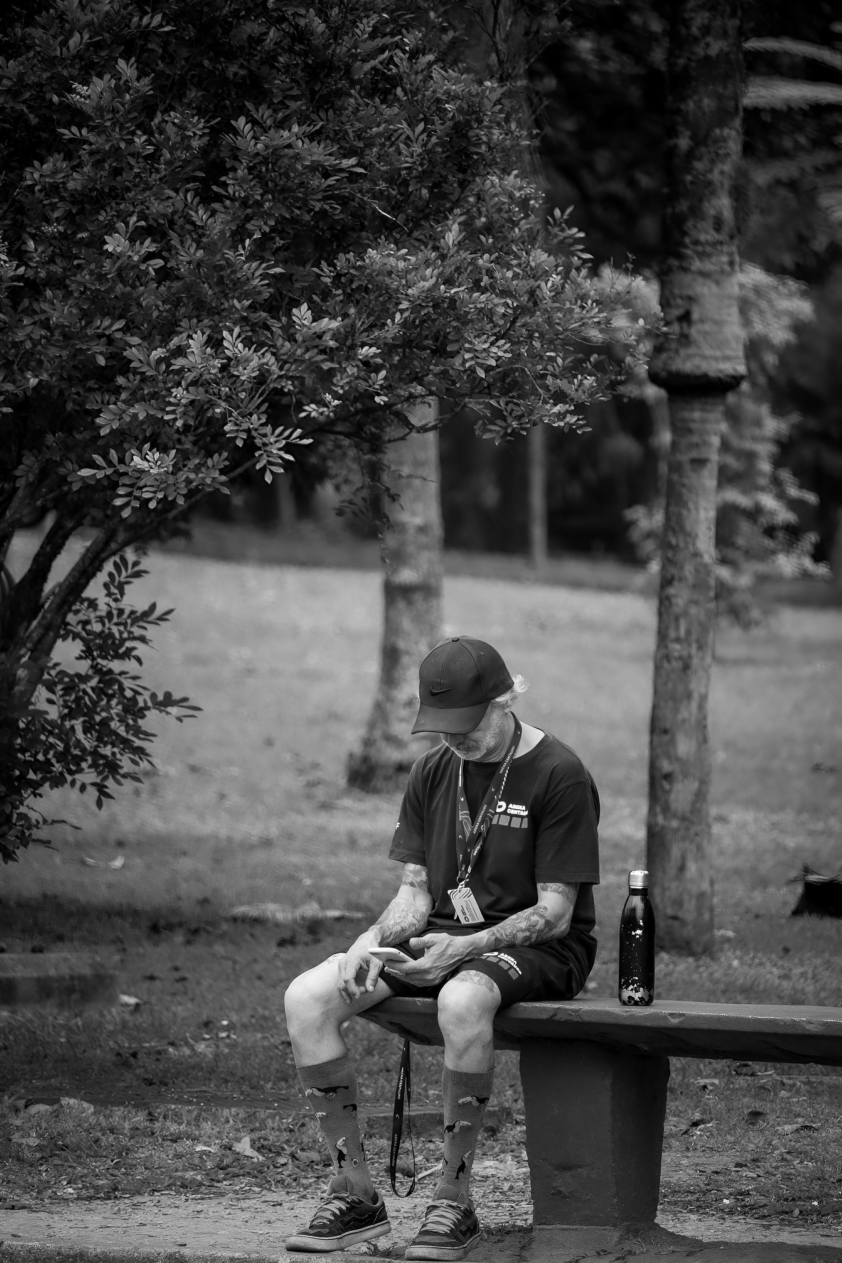 A man sitting on a bench with his dog · Free Stock Photo