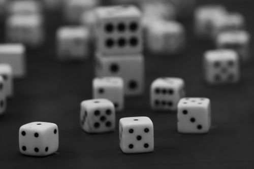 Free Black and white photo of scattered dice, focusing on one die in sharp detail. Stock Photo