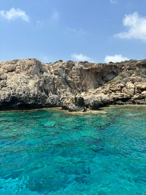 Free Discover the vivid turquoise waters and rocky shoreline of Ayia Napa, Cyprus's stunning beach landscape. Stock Photo