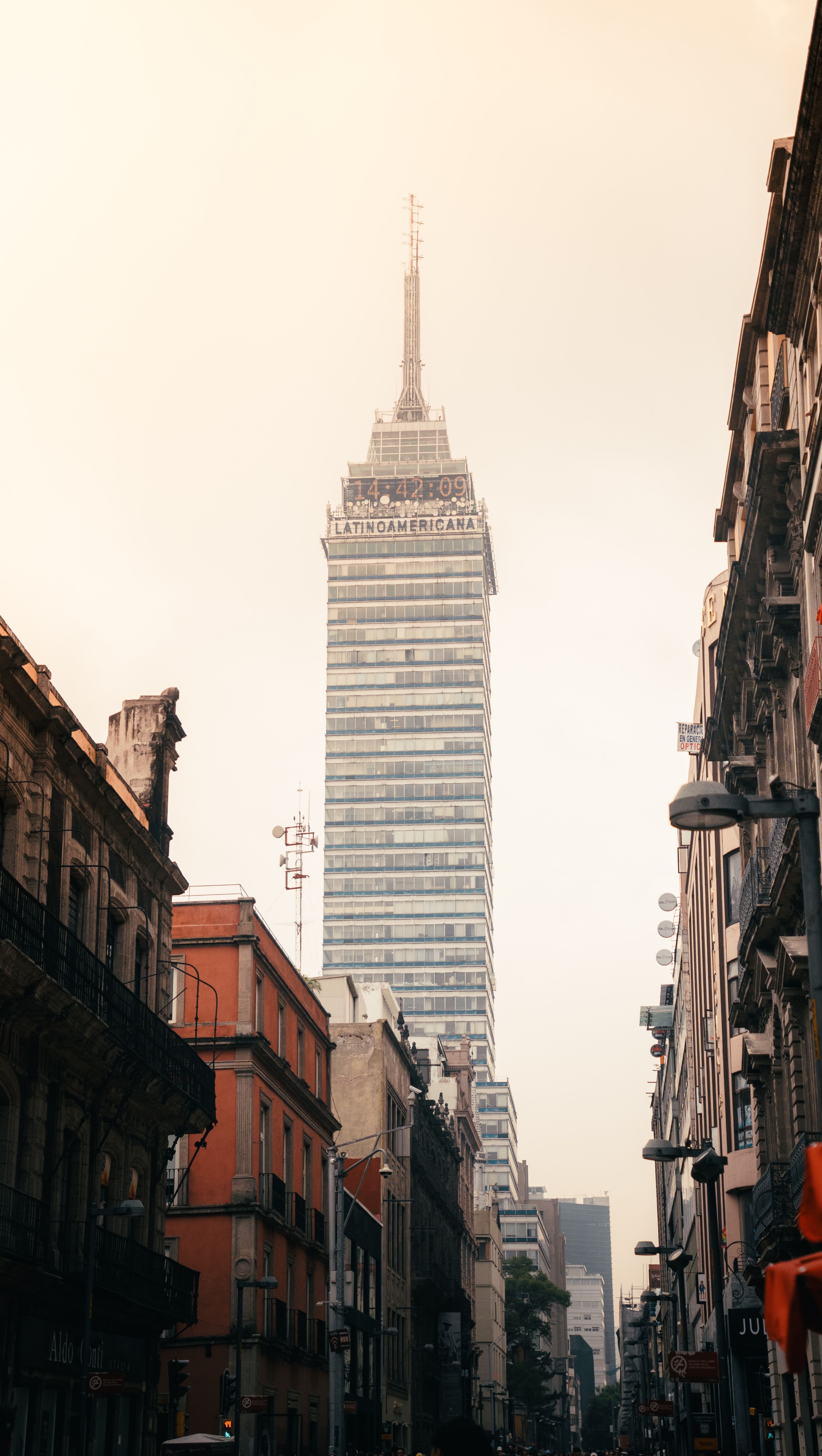 View of Torre Latinoamericana surrounded by classic architecture in downtown Mexico City.
