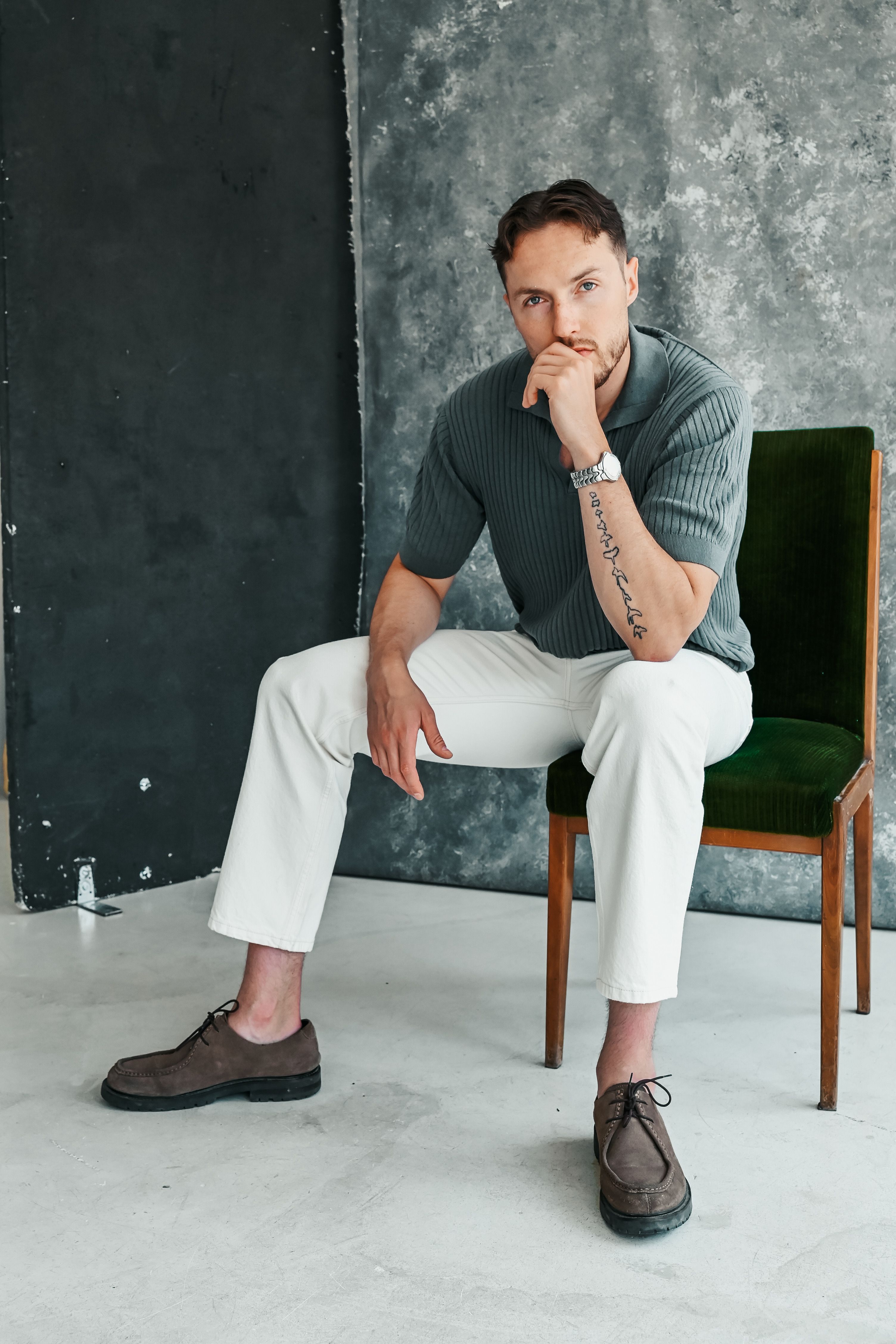 Man Sitting and Posing by Wall · Free Stock Photo