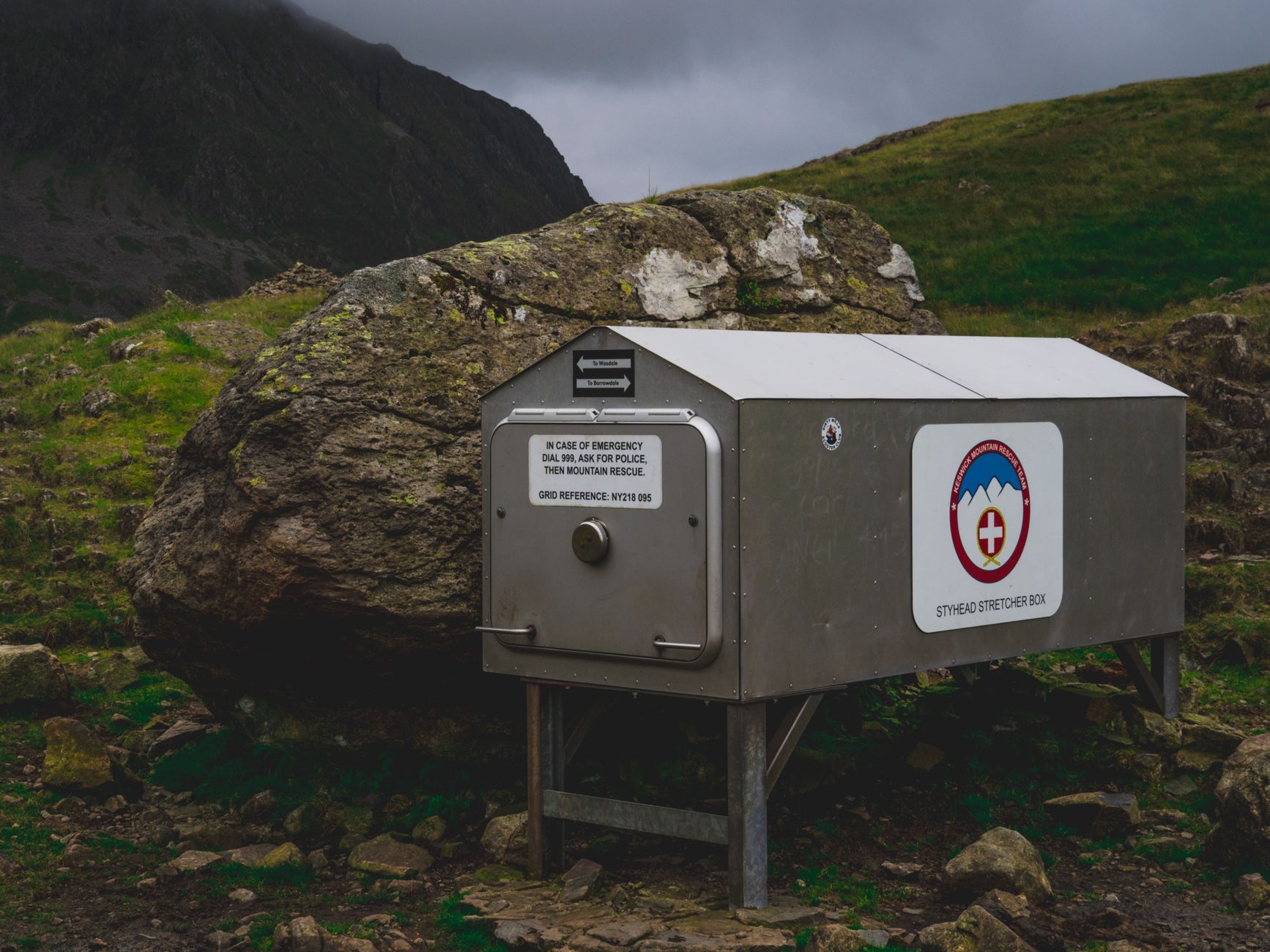 A mountain rescue box situated in a highland landscape, providing emergency services.