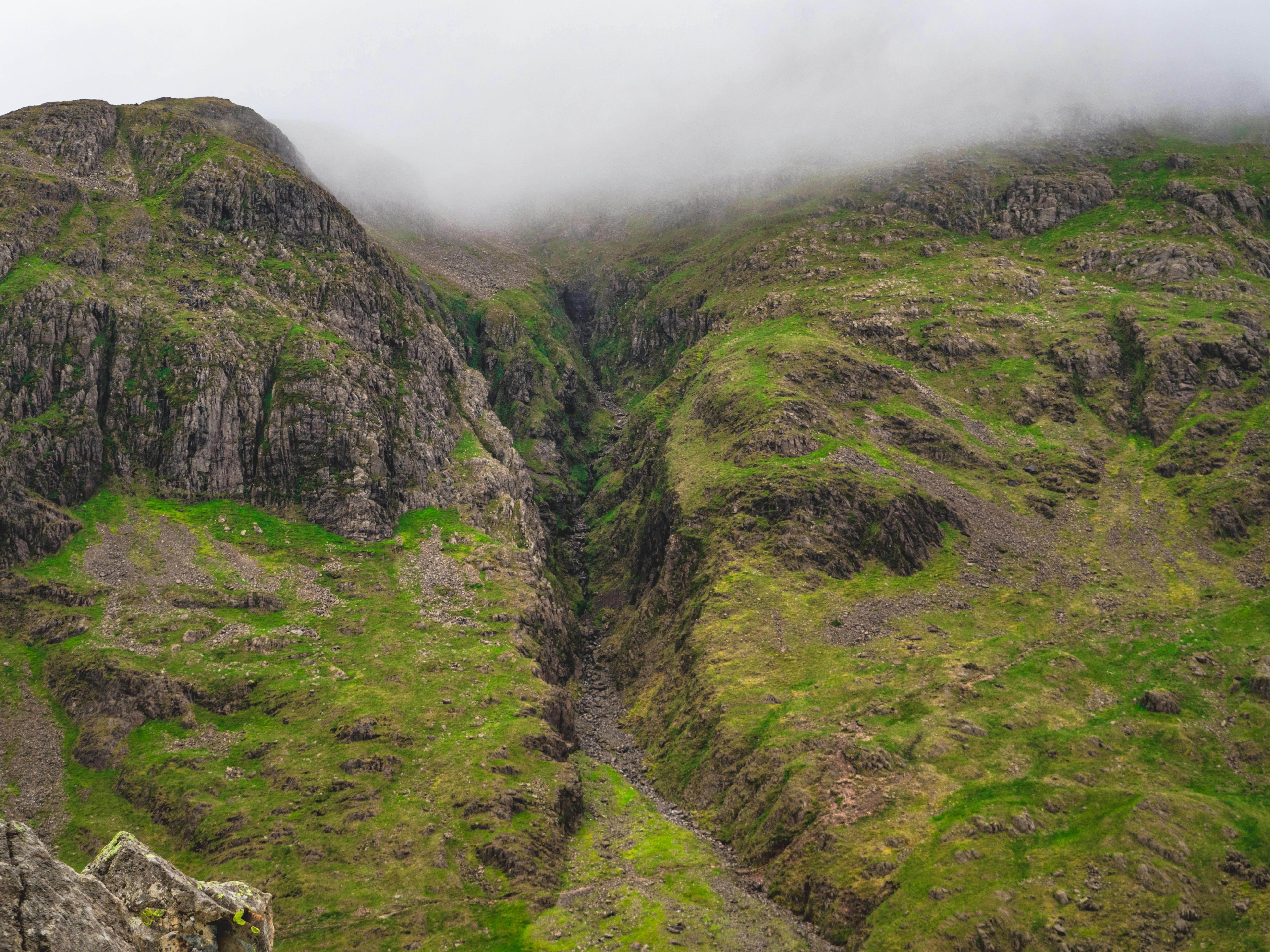 a mountain with a valley and a green valley