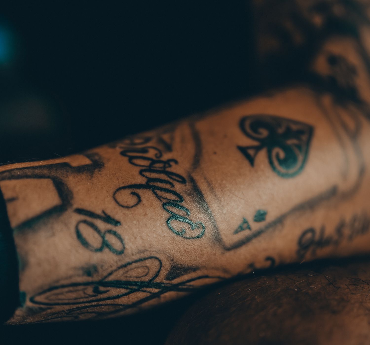 Detailed view of an intricate tattoo on a forearm, showcasing artistic design.