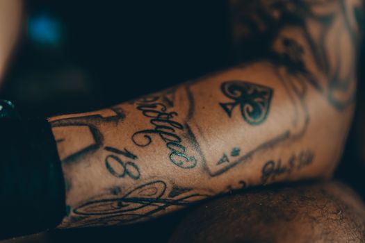 Detailed view of an intricate tattoo on a forearm, showcasing artistic design.