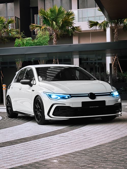 Free A stylish white car parked in a modern urban environment, showcasing luxury and design. Stock Photo