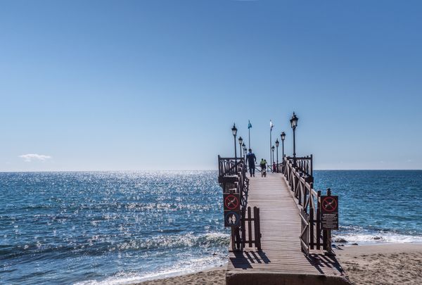 View from a Marbella marina pier with boats moored ready to sail