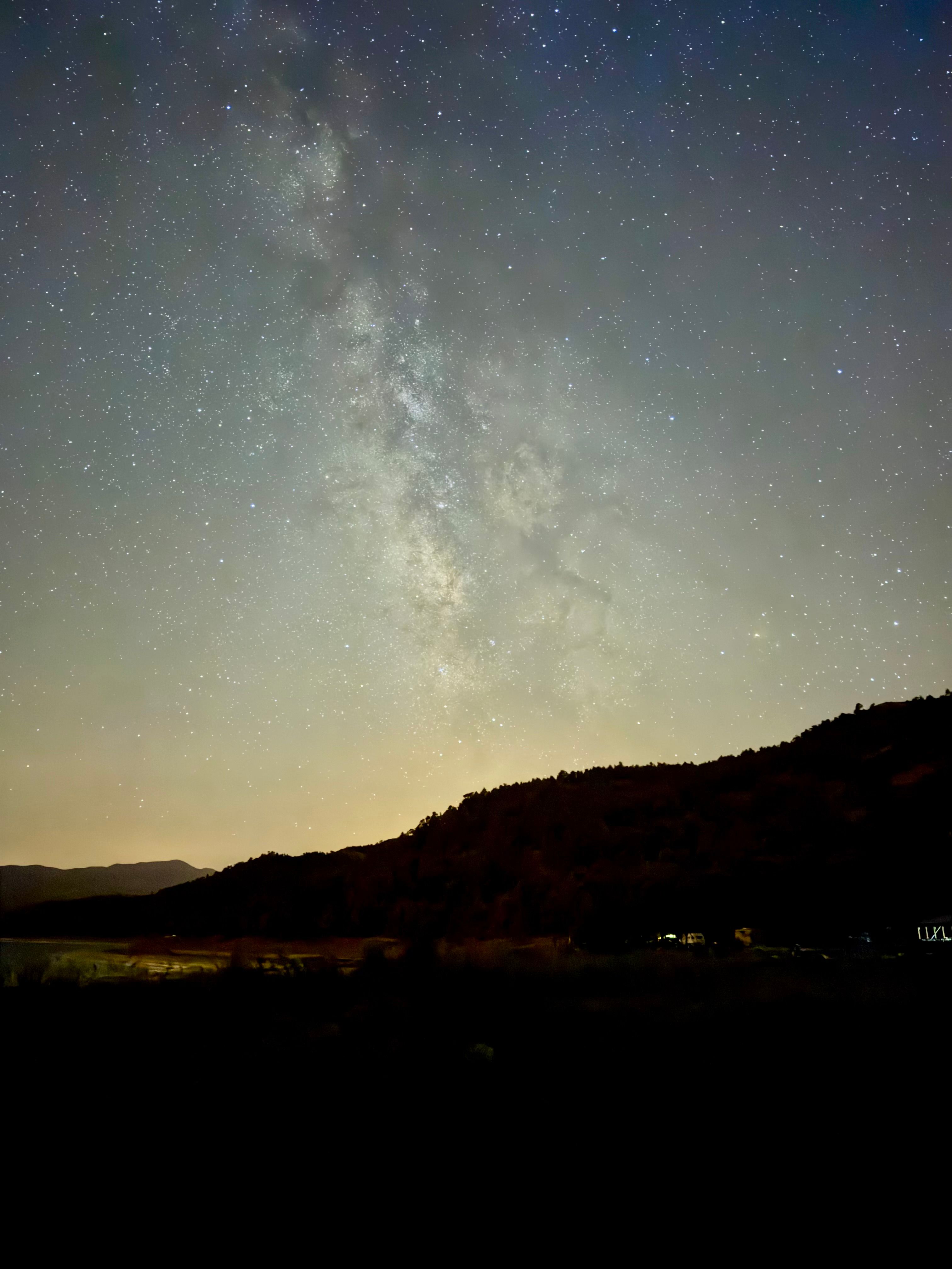 The milky way over the mountains in the night sky · Free Stock Photo