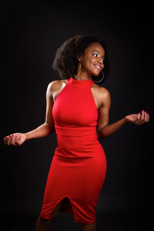 red dress black background Beautiful woman in red dress isolated on black background. Studi Stock Photo