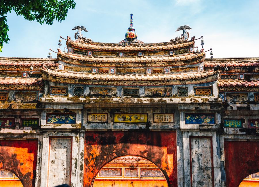 Explore the intricate architecture of a historic gate in the Imperial City of Hue, Vietnam.