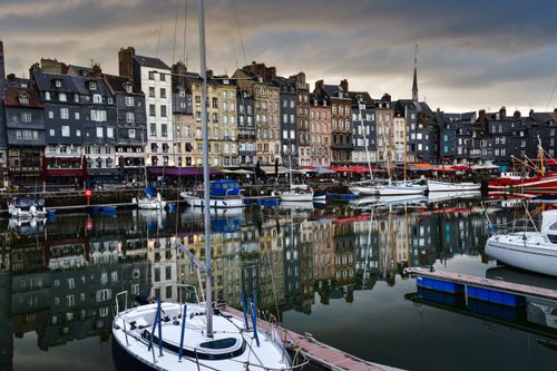 Free Scenic view of Honfleur harbor in Normandy, France showcasing yachts and colorful buildings. Stock Photo