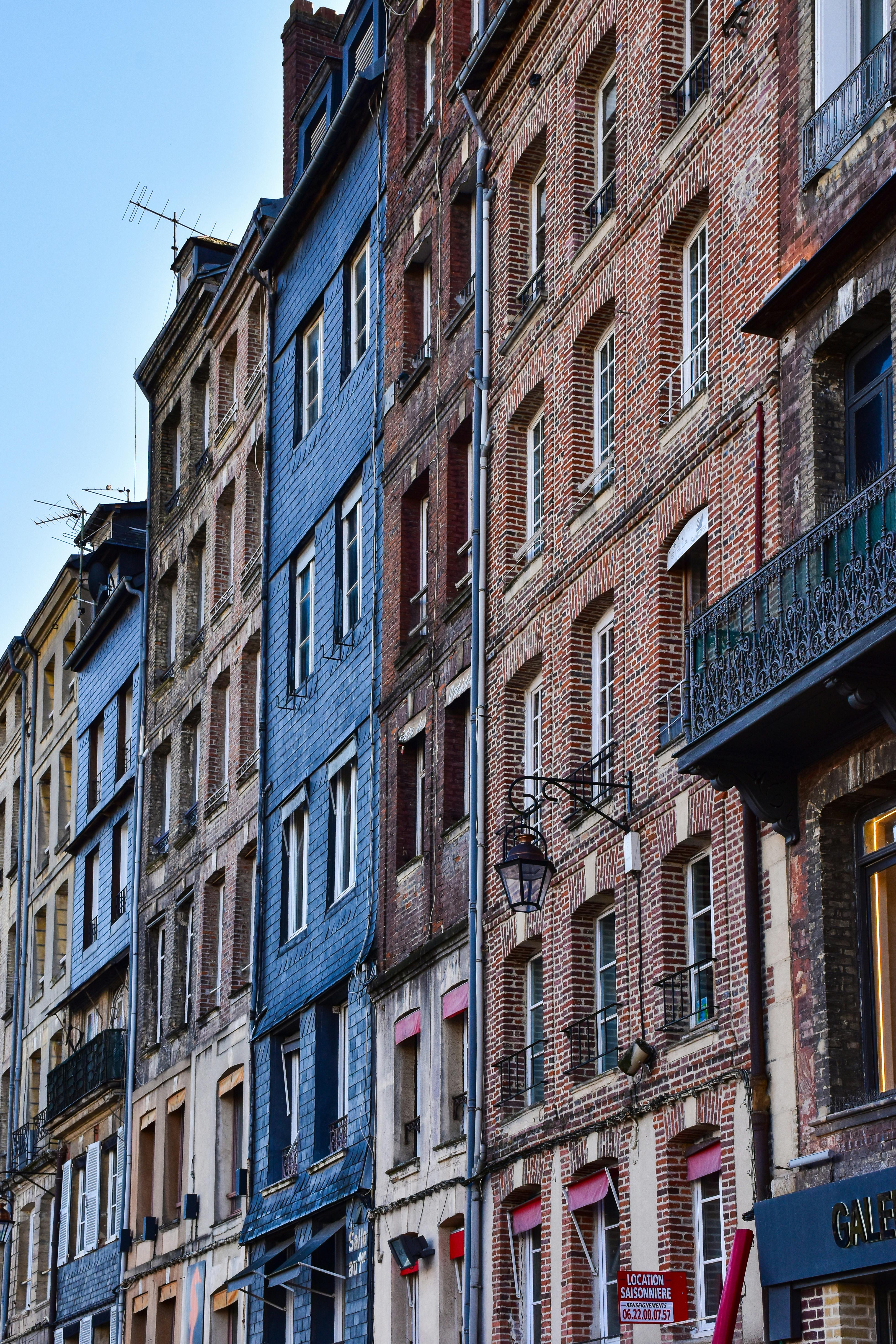 a street with many buildings and cars parked on it