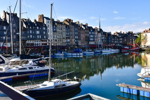 Free Beautiful harbor scene in Honfleur, Normandy with boats and charming buildings. Stock Photo