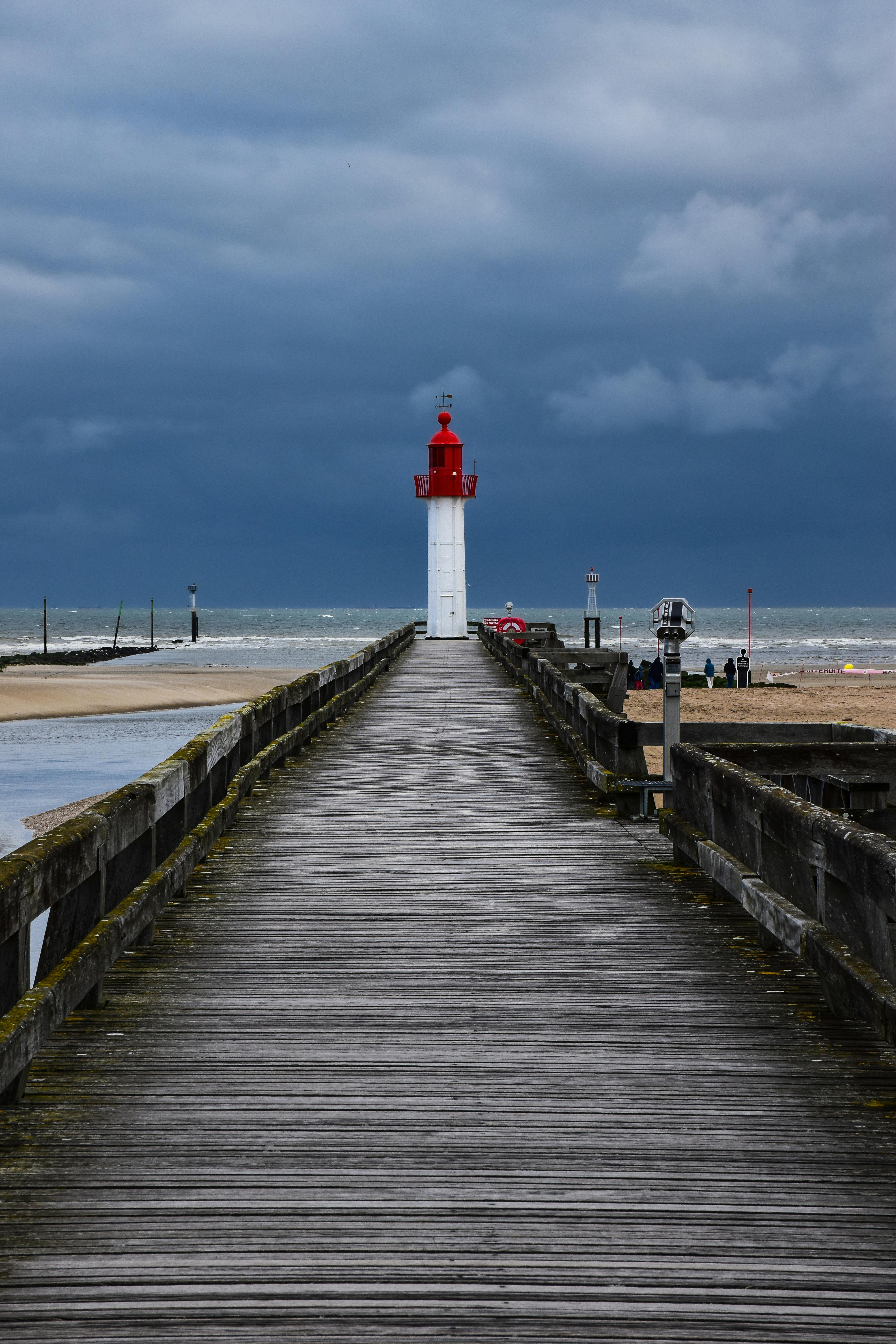 Two Person Standing Near White Lighthouse · Free Stock Photo