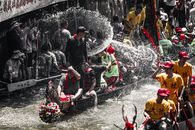 A vibrant dragon boat race showcasing teamwork and cultural celebration on a bustling city waterway.